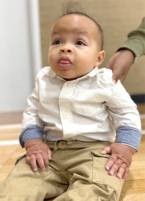 Infant boy sitting up 