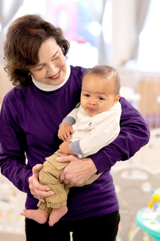 Teacher caring for infant