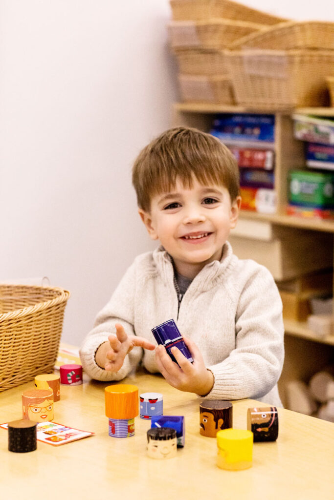 Small boy playing with puzzle at desk